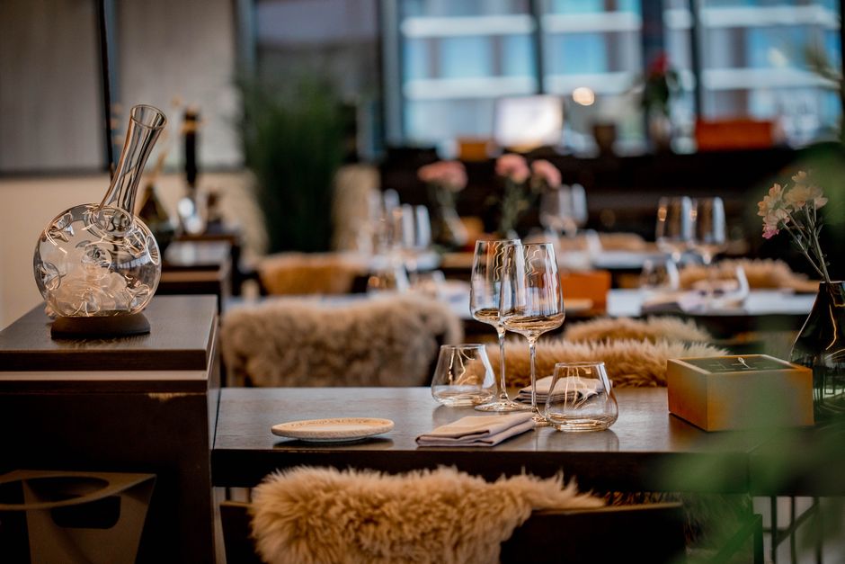 Cultura São Paulo — Chic restaurant interior featuring elegant glassware, tableware, and cozy decor.